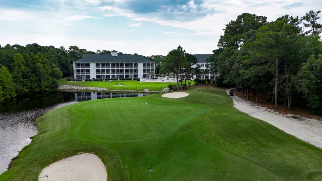 River Hills Golf Club features a smooth green with sand traps, water views, and a backdrop of cozy golf villas. This spot blends resort-style living with a peaceful golf experience.