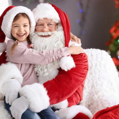 little girl on santa's lap at golden isles holiday event