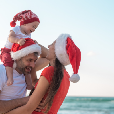 family in santa hats on a st simons island beach