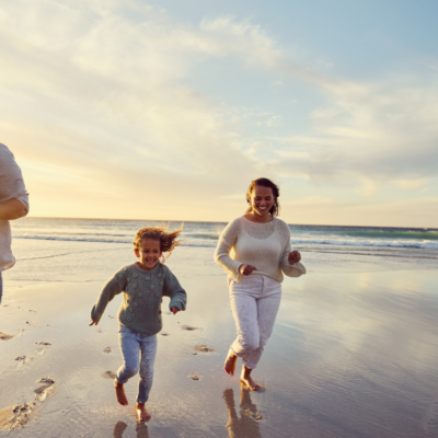 family running on st simons beach in winter