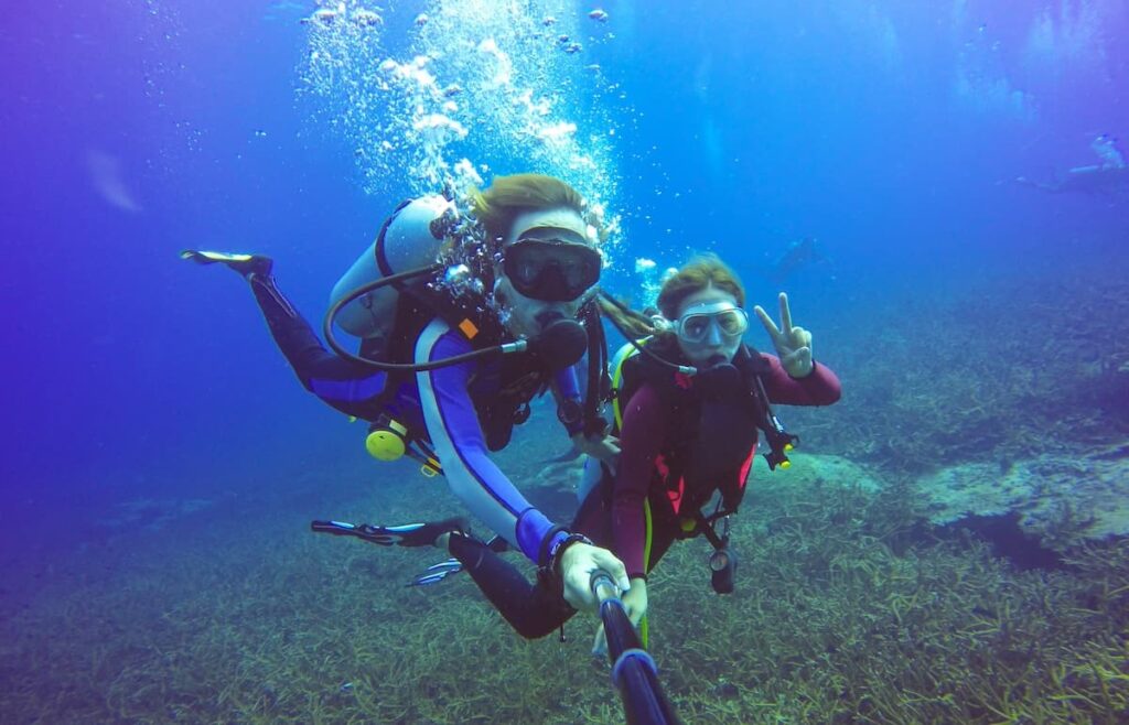 Couple scuba diving while on their honeymoon in Tamarindo Costa Rica