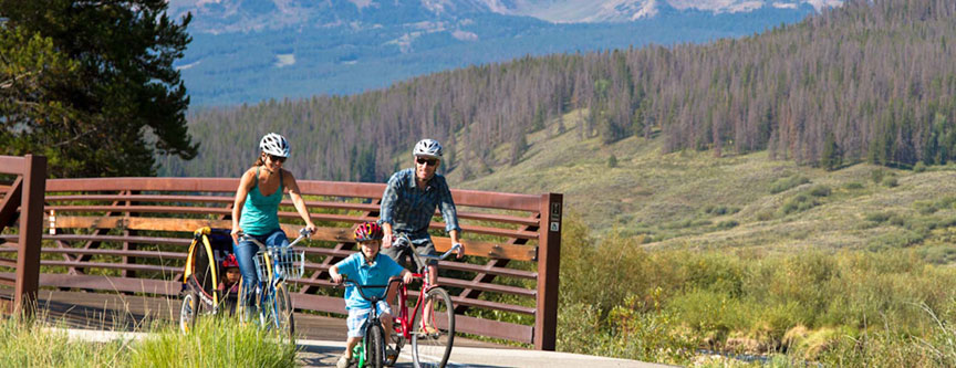 A family enjoys a bicycle ride through the aspen groves near Breckenridge, Colorado.