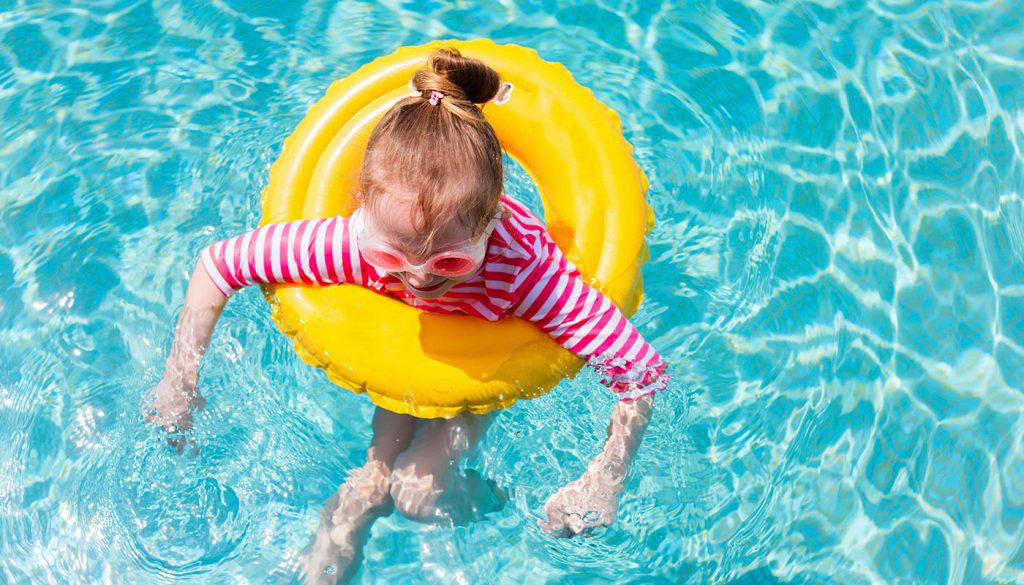 little girl on a floatie in the pool