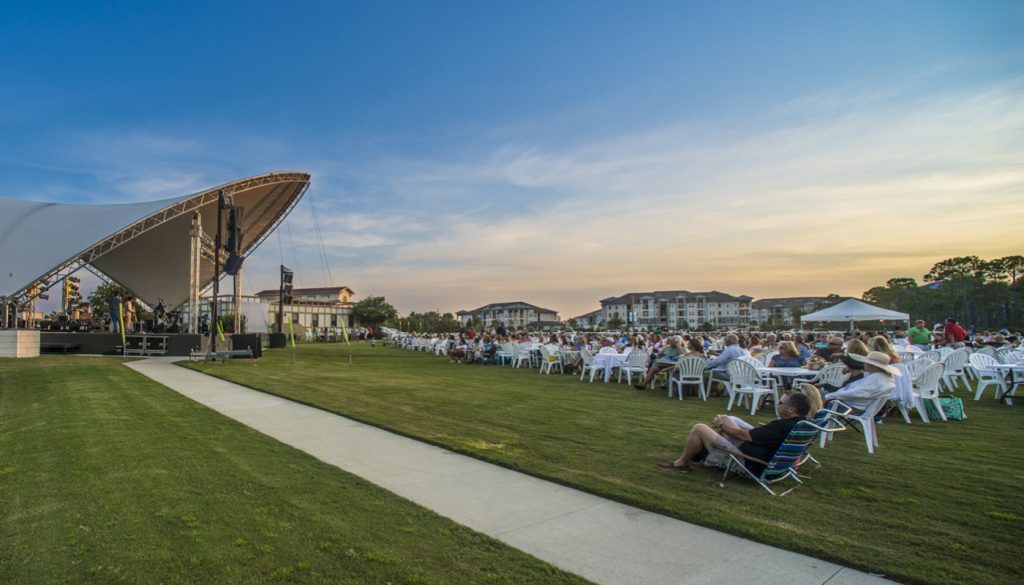 group of people gathered at a 30a event outside on the lawn