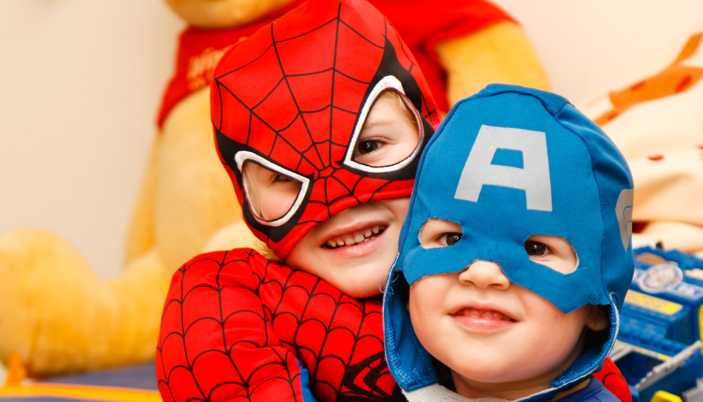 two boys dressed in super hero costumes for Halloween