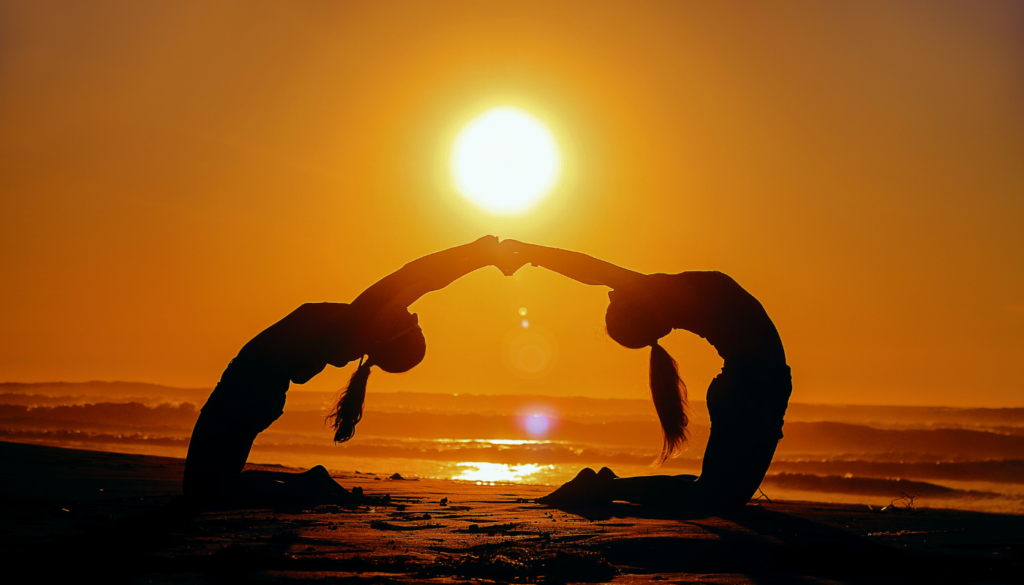 two girls doing yoga at the beach at sunrise