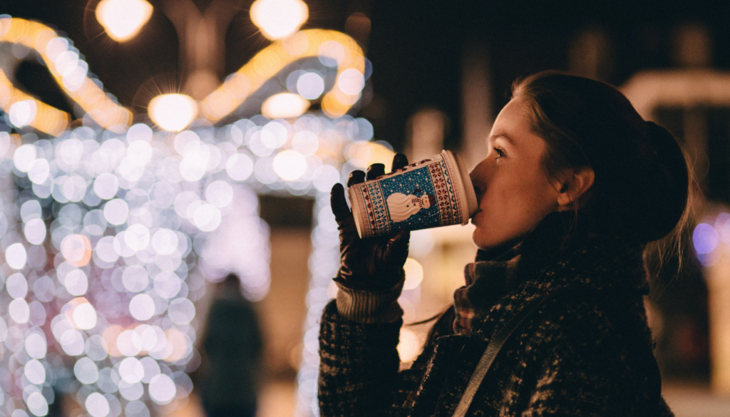 girl sipping hot chocolate at a winter event in destin