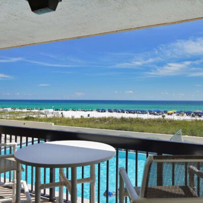 view from the balcony of a destin vacation rental overlooking the pool and beach