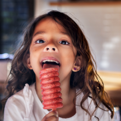 girl eating a frozen treat