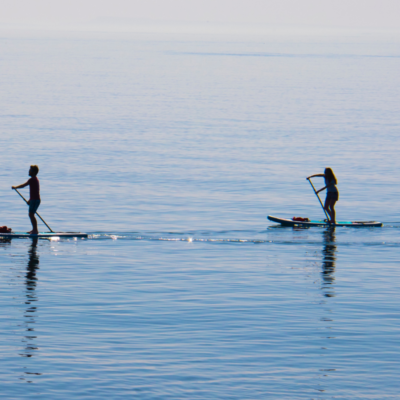 couple paddleboarding on water