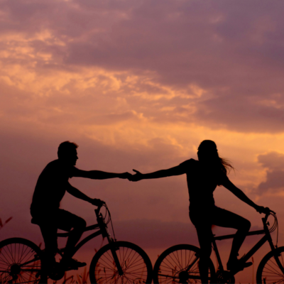 couple bike riding at sunsset