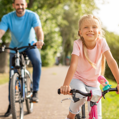 dad and daughter bike riding on 30a