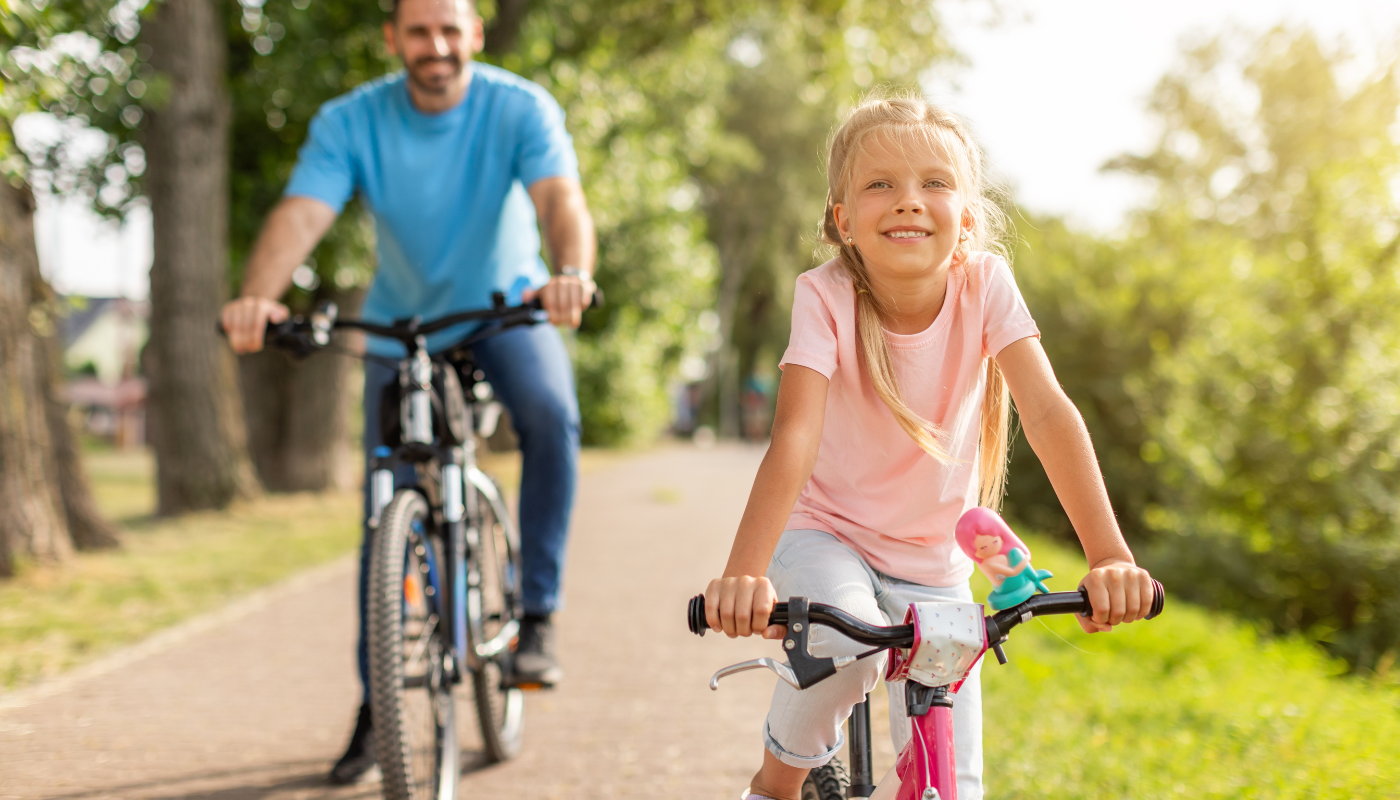 dad and daughter bike riding on 30a