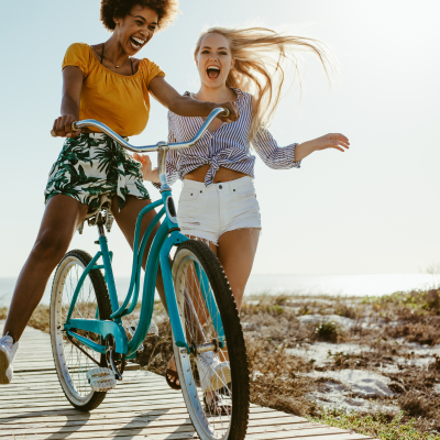 two girls riding bikes on the beach in Destin
