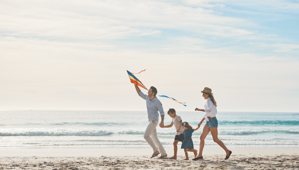 family with small children walking along a northwest florida beach