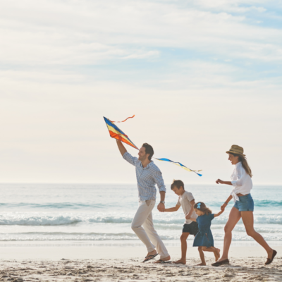 family with small children walking along a northwest florida beach
