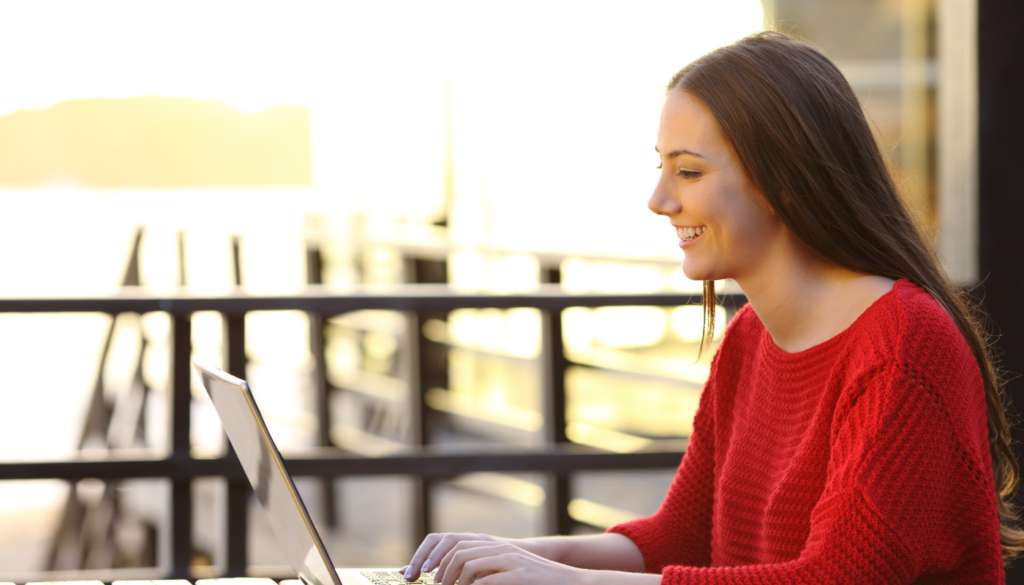 girl working on her computer during an extended stay vacation in northwest florida