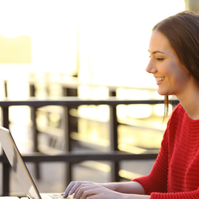 girl working on her computer during an extended stay vacation in northwest florida