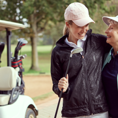 mother and daughter golfing in northwest florida during winter
