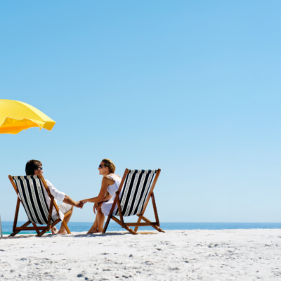 couple on the beach using scenic stays concierge services