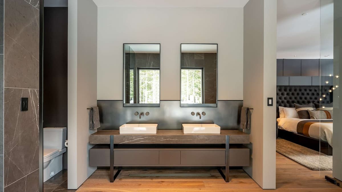 Modern en suite bathroom and twin sinks and brown marble finishings