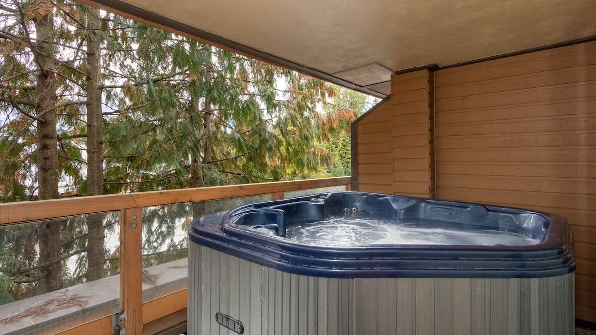 Large hot tub on private balcony overlooking trees