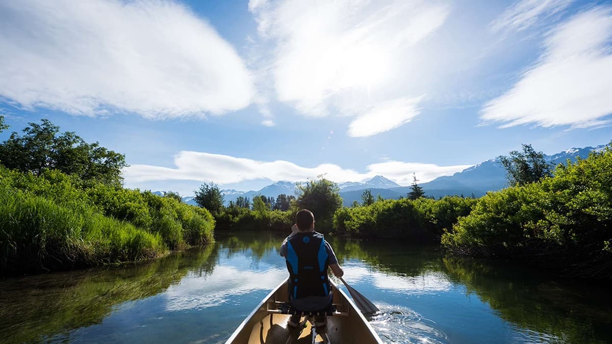 Man canoeing in Whistler along the River of Golden Dreams where you can get guided tours