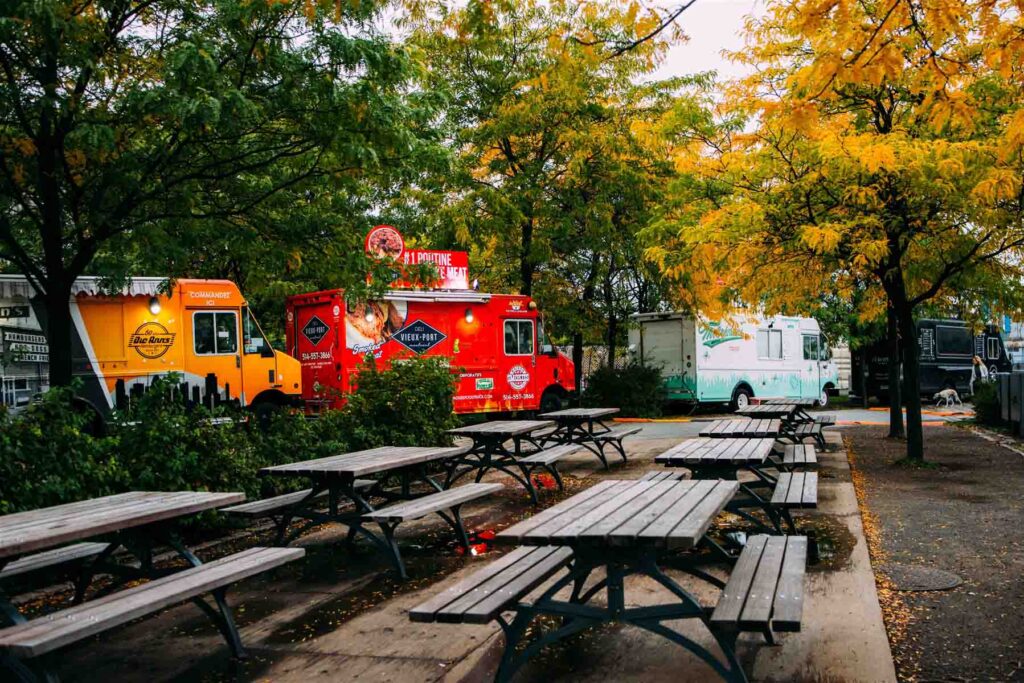Four food trucks and picnic tables