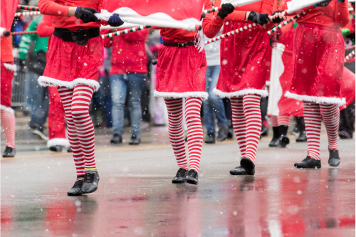 People in Red and White Stockings in a Holiday Parade