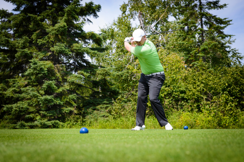 Person Teeing Off on Golf Course in Bend Oregon
