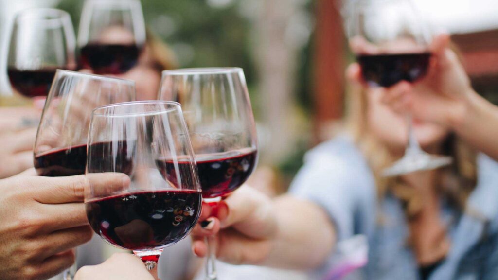 people cheersing with wine