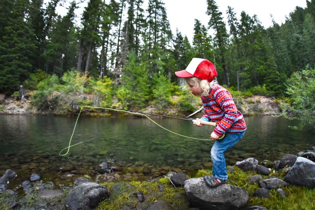 little girl playing in creek