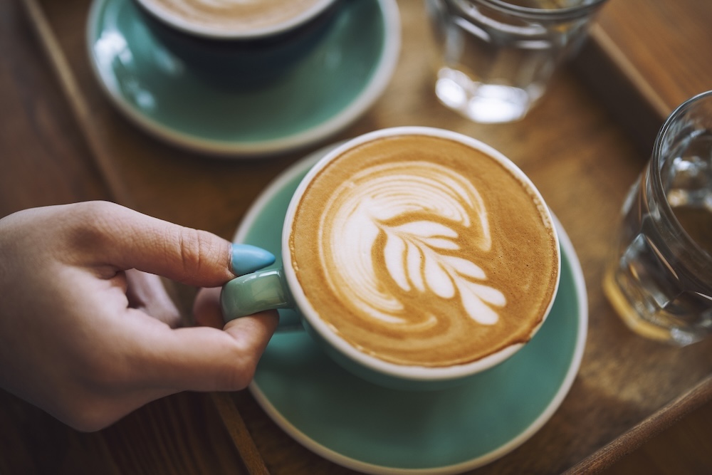 cup of coffee with design in the foam