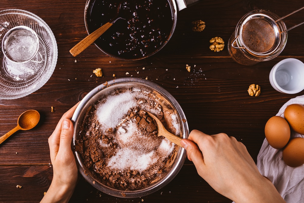 Top view female hands mix cocoa powder