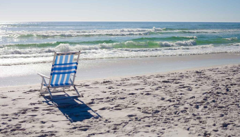empty beach chair along the shoreline