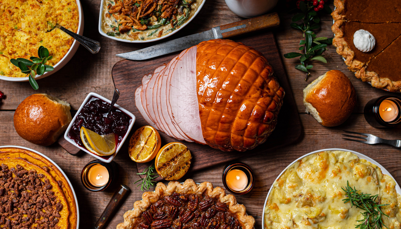 thanksgiving table filled with turkey, pies, and side dishes