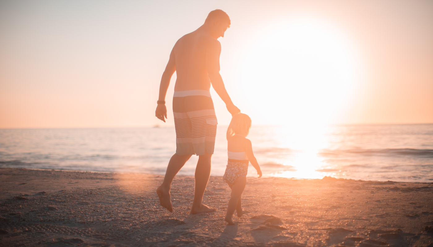 father and son walking along the beach in orange beach, alabama