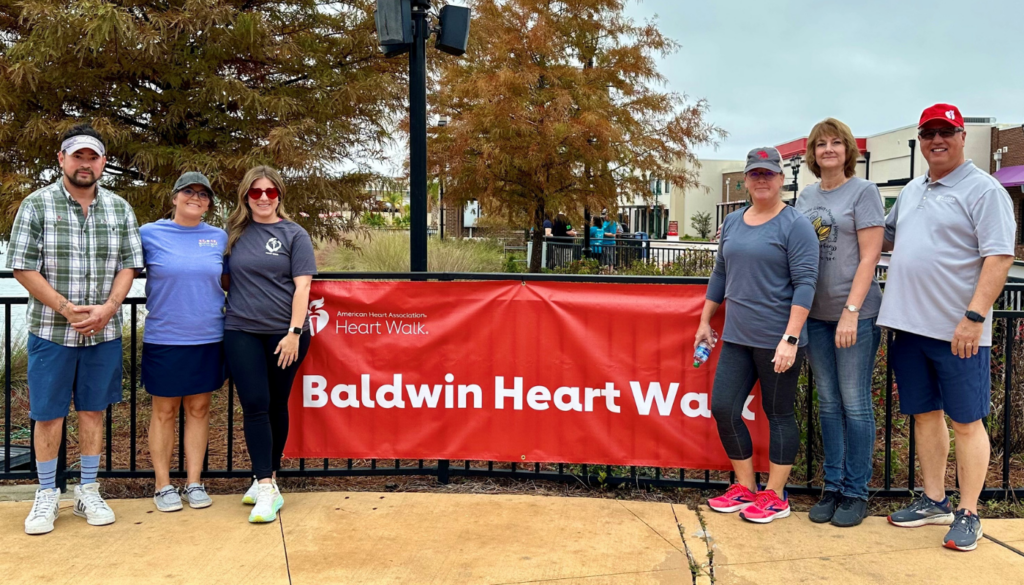 kaiser team in front of a banner that says baldwin heart walk
