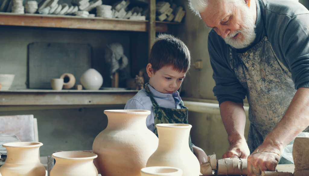 little boy learning how to make pottery in gulf shores