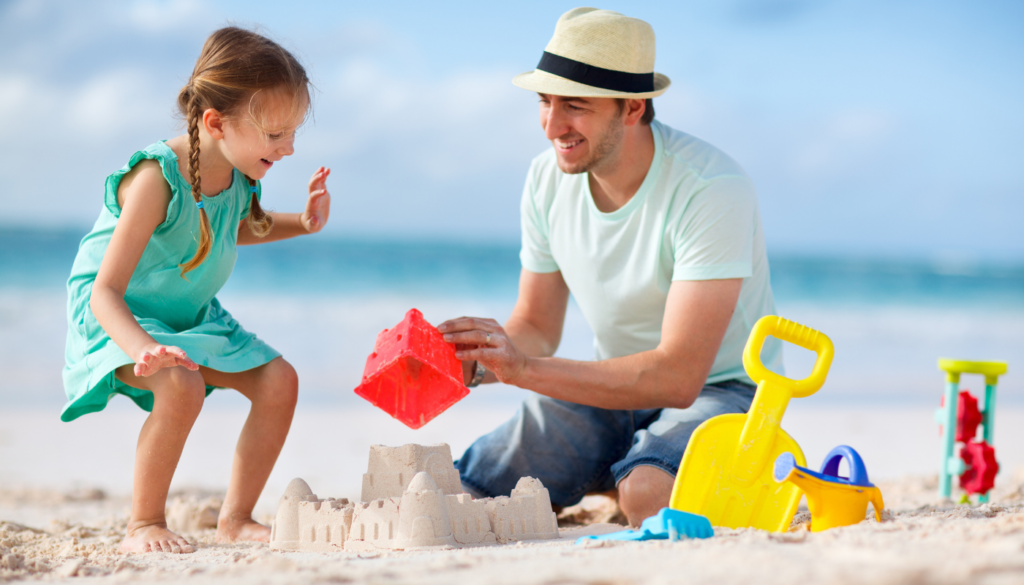 dad and daughter building sand castles in gulf shores