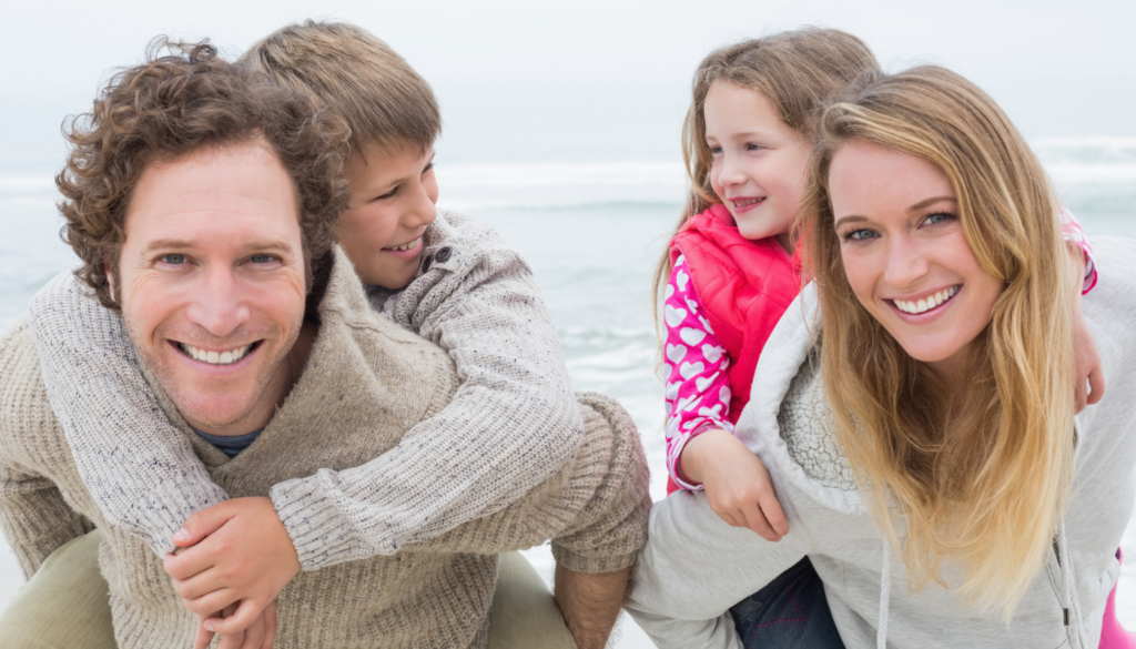 family walking on the beach in winter in gulf shores, alabama