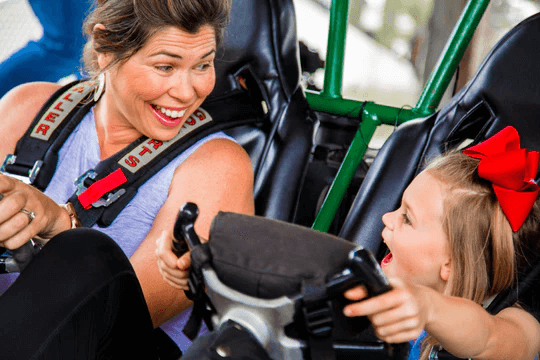 A perfect family-friendly holiday in Destin - Mom and daughter riding at The Track Family Recreation Center