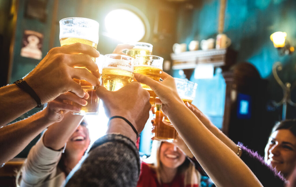 Friends lifting glasses of beer in a toast.