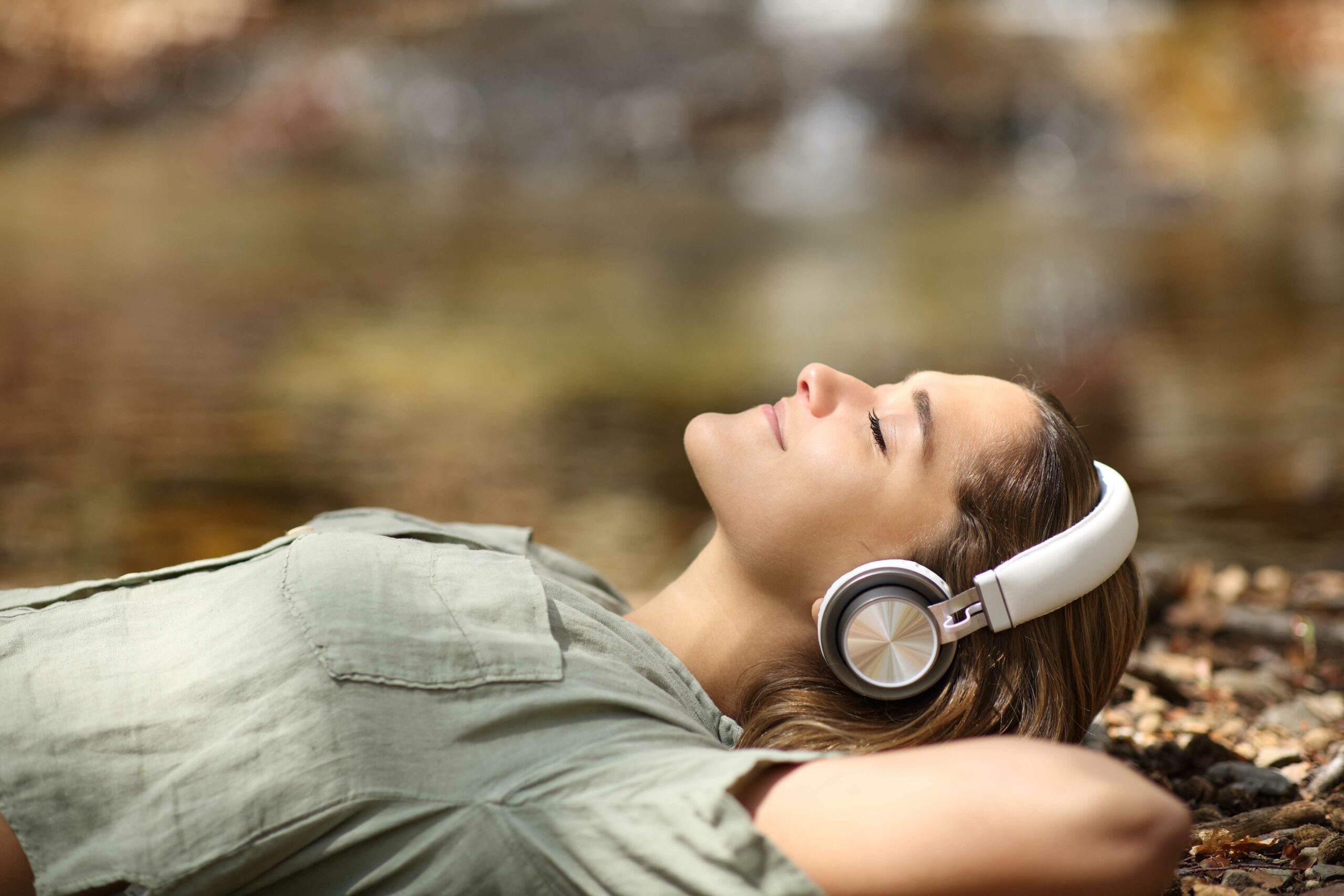image of woman listening to music while lying