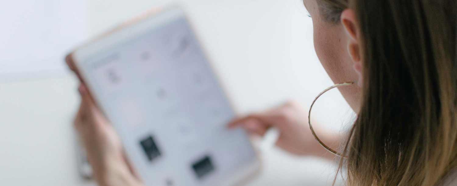 image of woman checking on tablet device