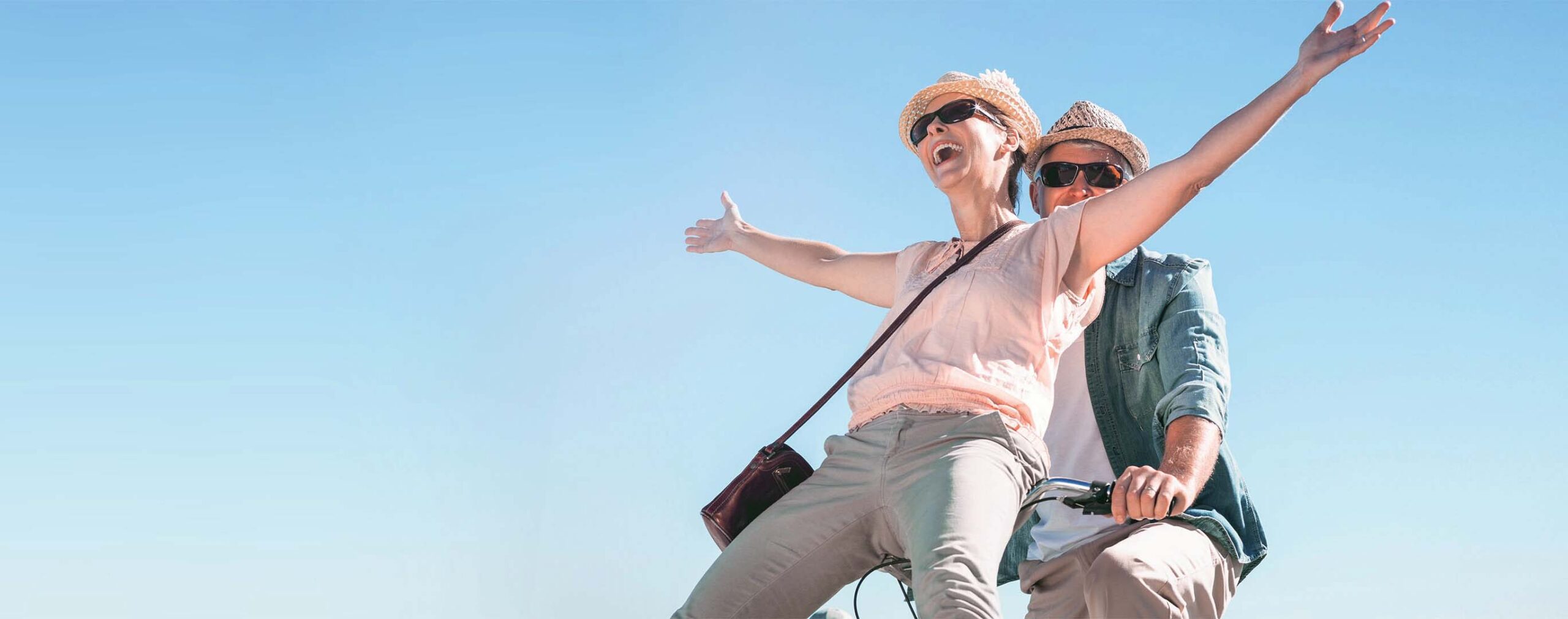 image of couple riding a bicycle