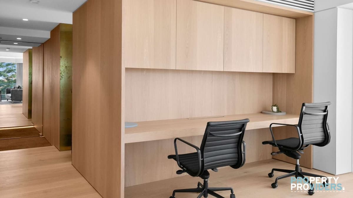 Light coloured wood study area with desk and two black office chairs, a perfect space when staying at a Luxury Corporate Accommodation in Northern Beaches