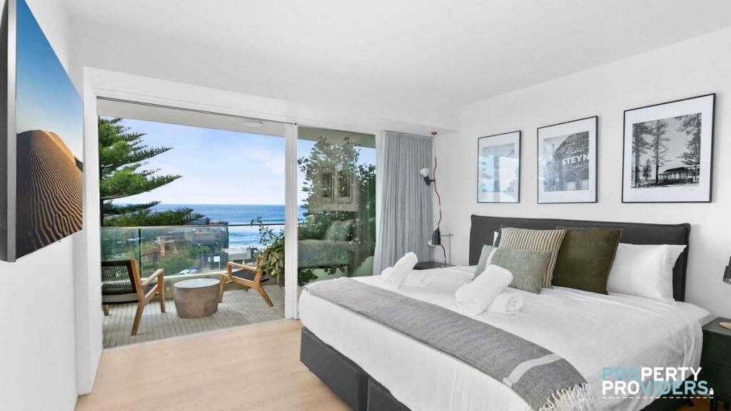 The master bedroom opens onto a balcony facing the ocean