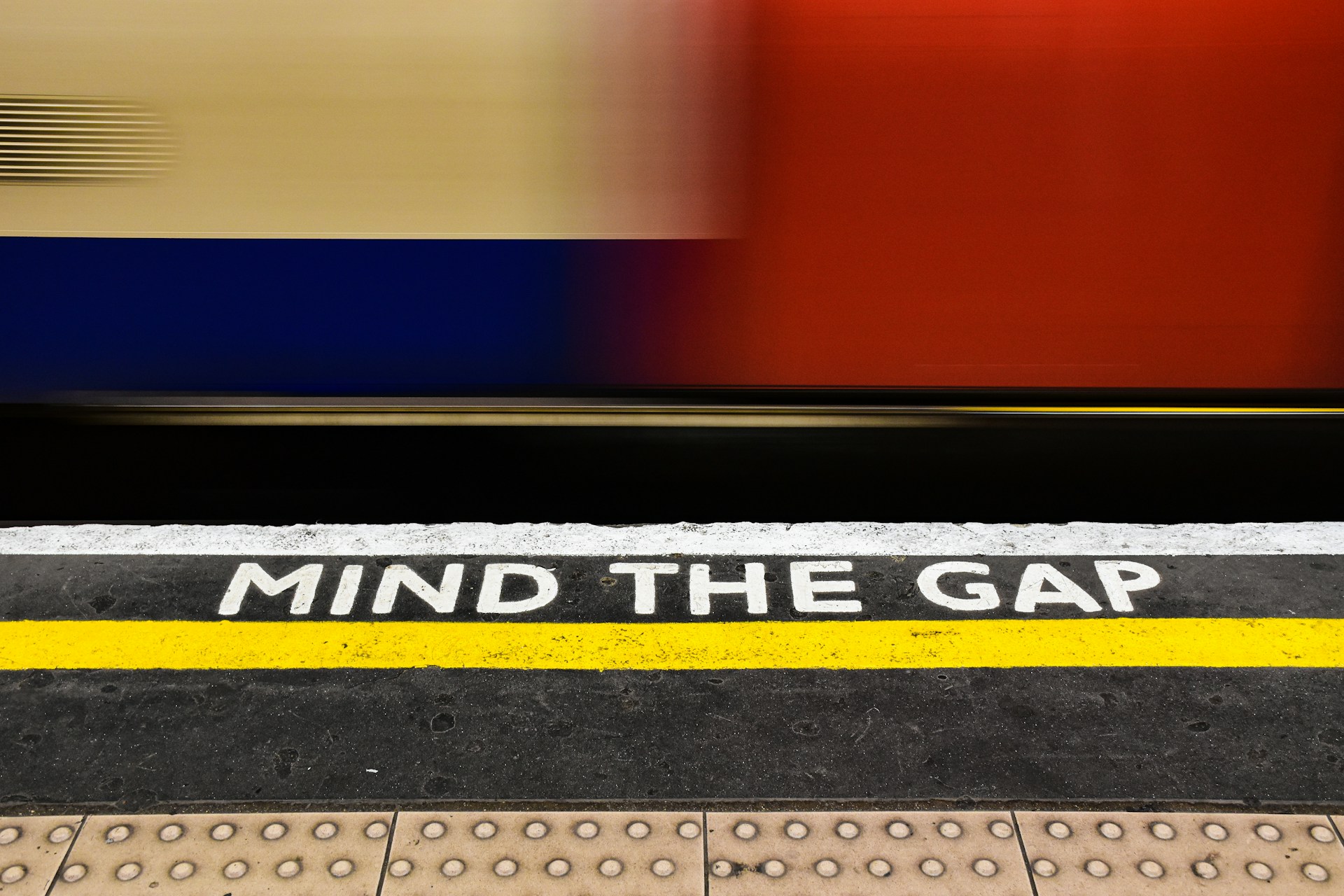 Mind the Gap sign at a train station, symbolizing careful attention to strata rules in NSW.