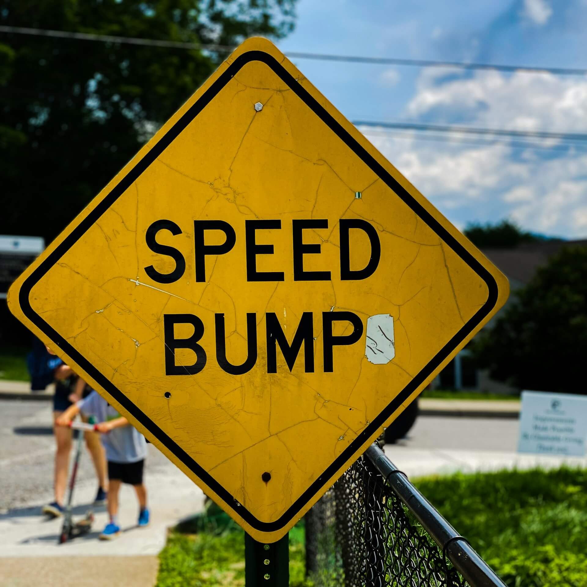 Yellow speed bump sign symbolizing potential challenges in strata management for short-term letting in NSW.